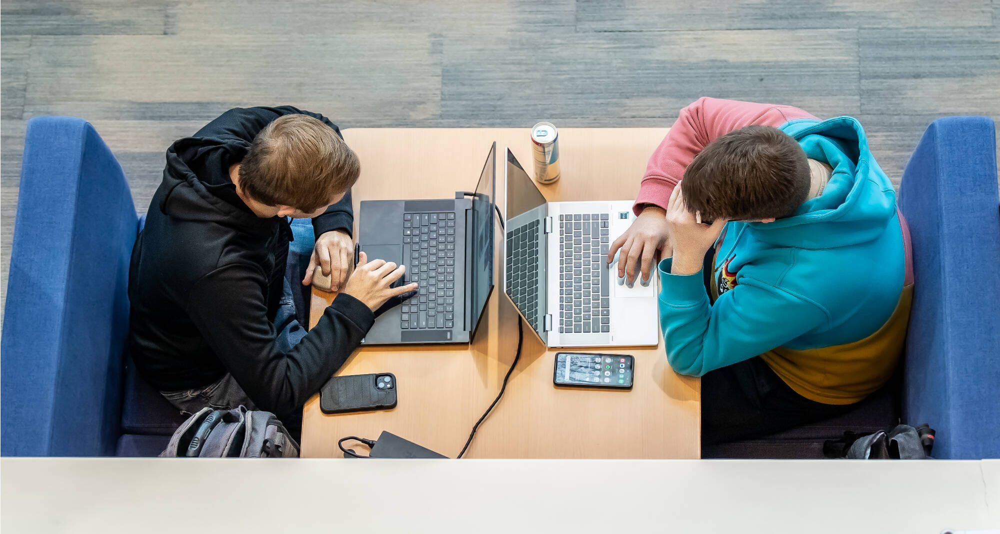 Two students are diligently preparing for final exams, utilizing the Mary Idema Pew Library's resources and collaborative spaces to support their academic success on December 4th.